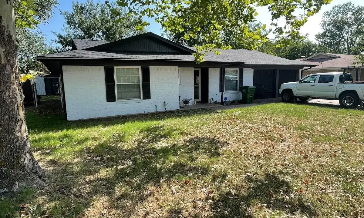 Professional roofing crew working on a residential roof in Rensselaer